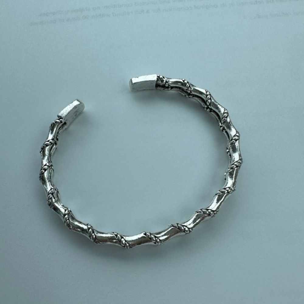 Silver tone weighted bamboo cable bracelet.